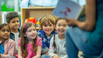 5 children listening to an adult read