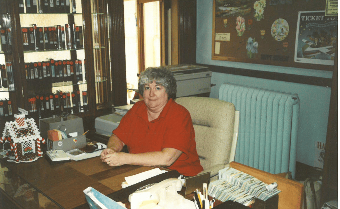 woman sitting at the library circulation desk