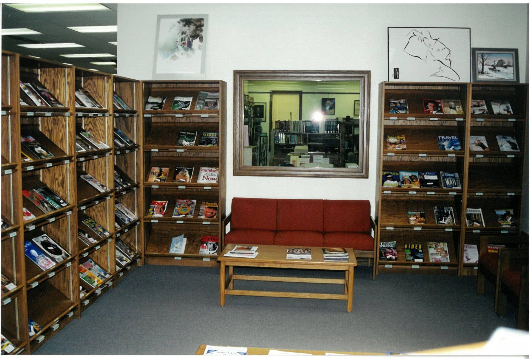 Magazines on shelves couch and coffee table