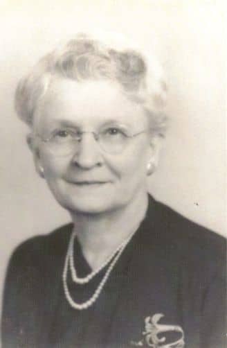 woman with glasses posing for photograph