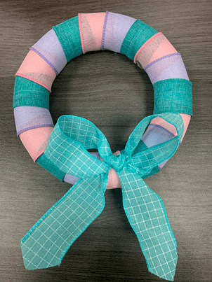 pink purple green wreath with green bow