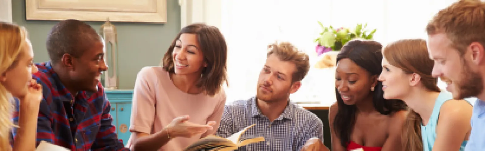 4 women 3 men discussing a book